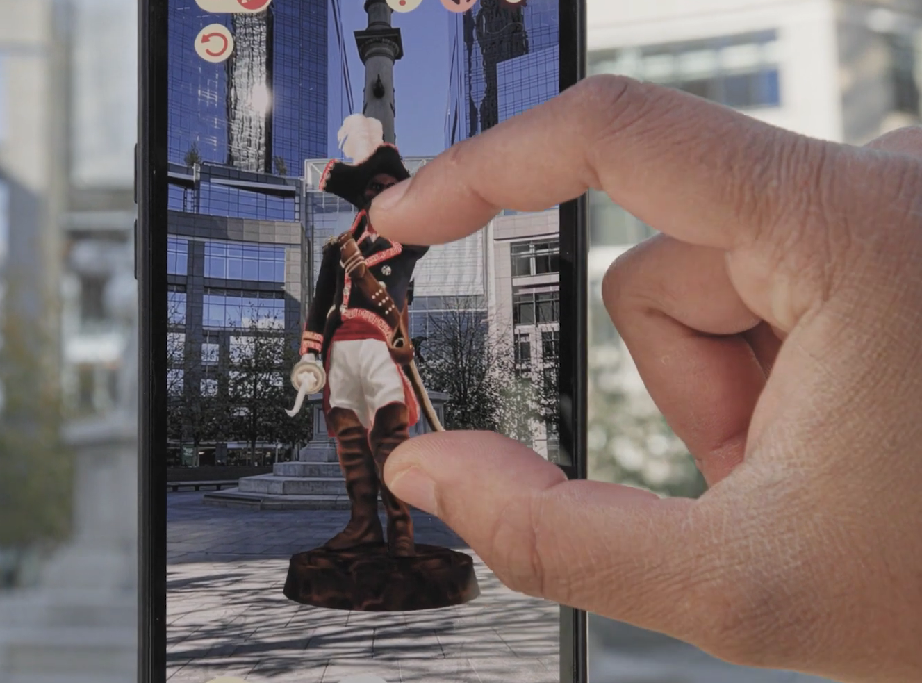 Fingers pinch Kinfolk app on phone.